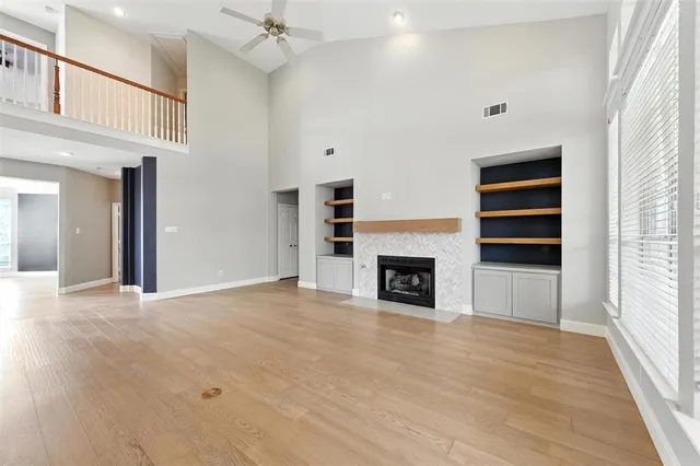a view of a livingroom with a fireplace and window
