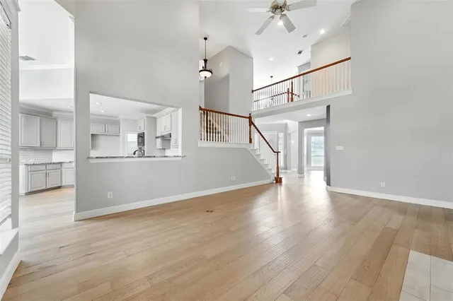 a view of a kitchen with furniture and wooden floor