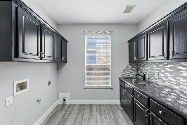 a kitchen with a sink stove and cabinets