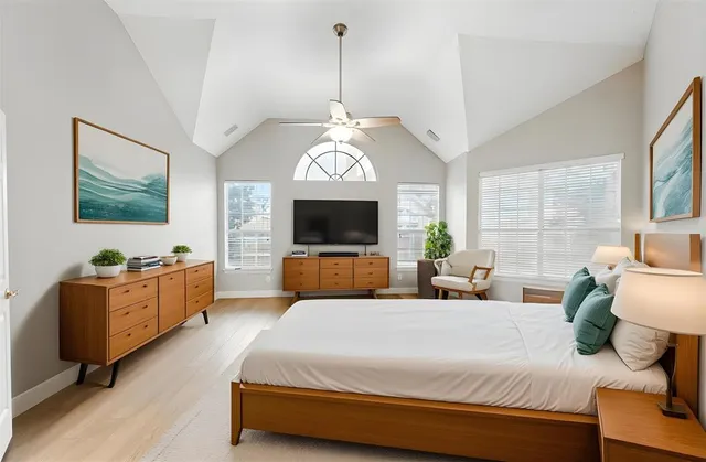 a bed room with a bed window and a flat screen tv