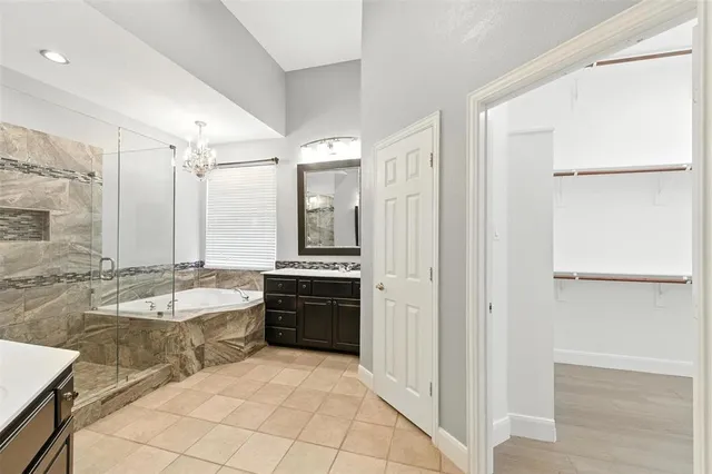 a large spacious bathroom with a granite countertop tub shower and sink