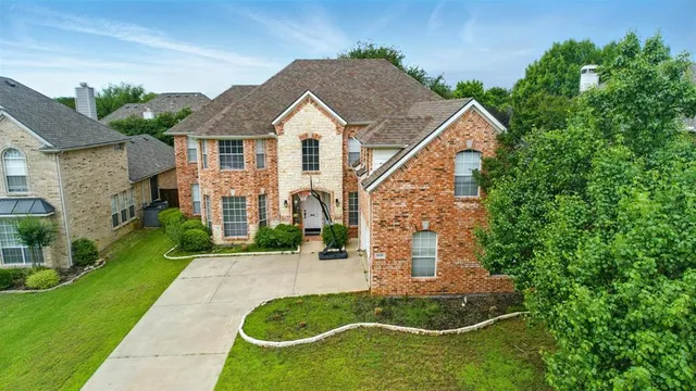 a view of a brick house with a yard