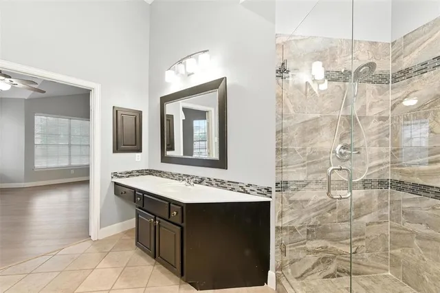 a bathroom with a sink vanity and a mirror