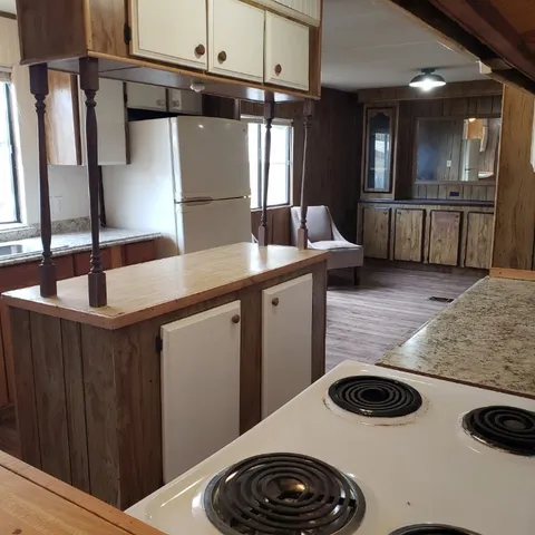 a kitchen with a stove and a refrigerator