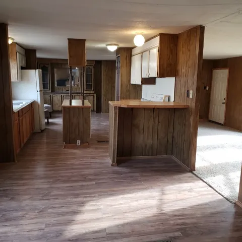 a view of kitchen with refrigerator and window