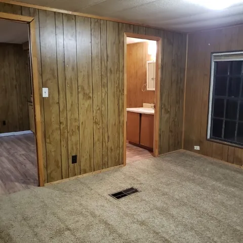 an empty room with closet and mirror