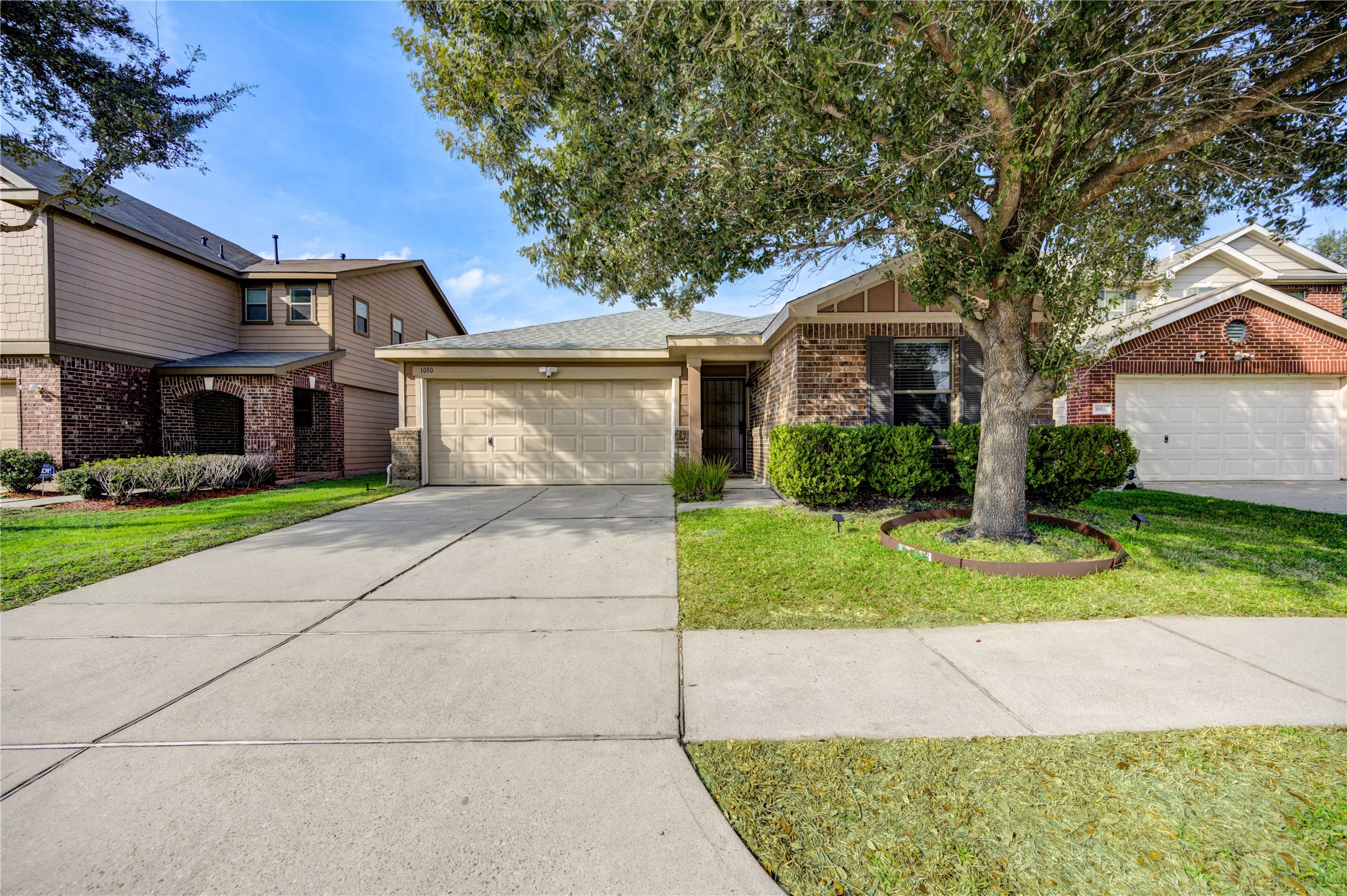 1010 Hummingbird Point Lane Houston, TX 77090 - Photo 2 of 50 a front view of a house with a yard and garage
