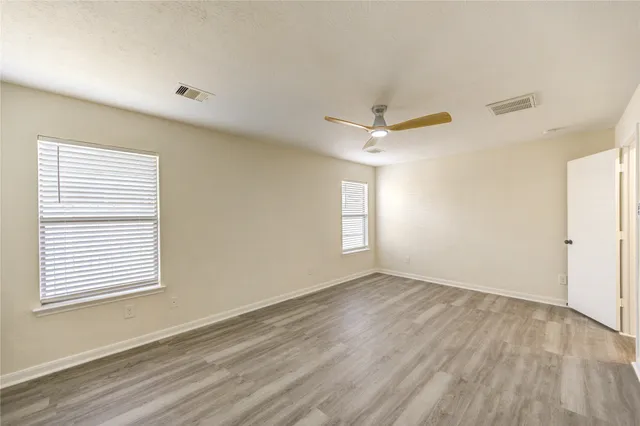 a view of an empty room and wooden floor