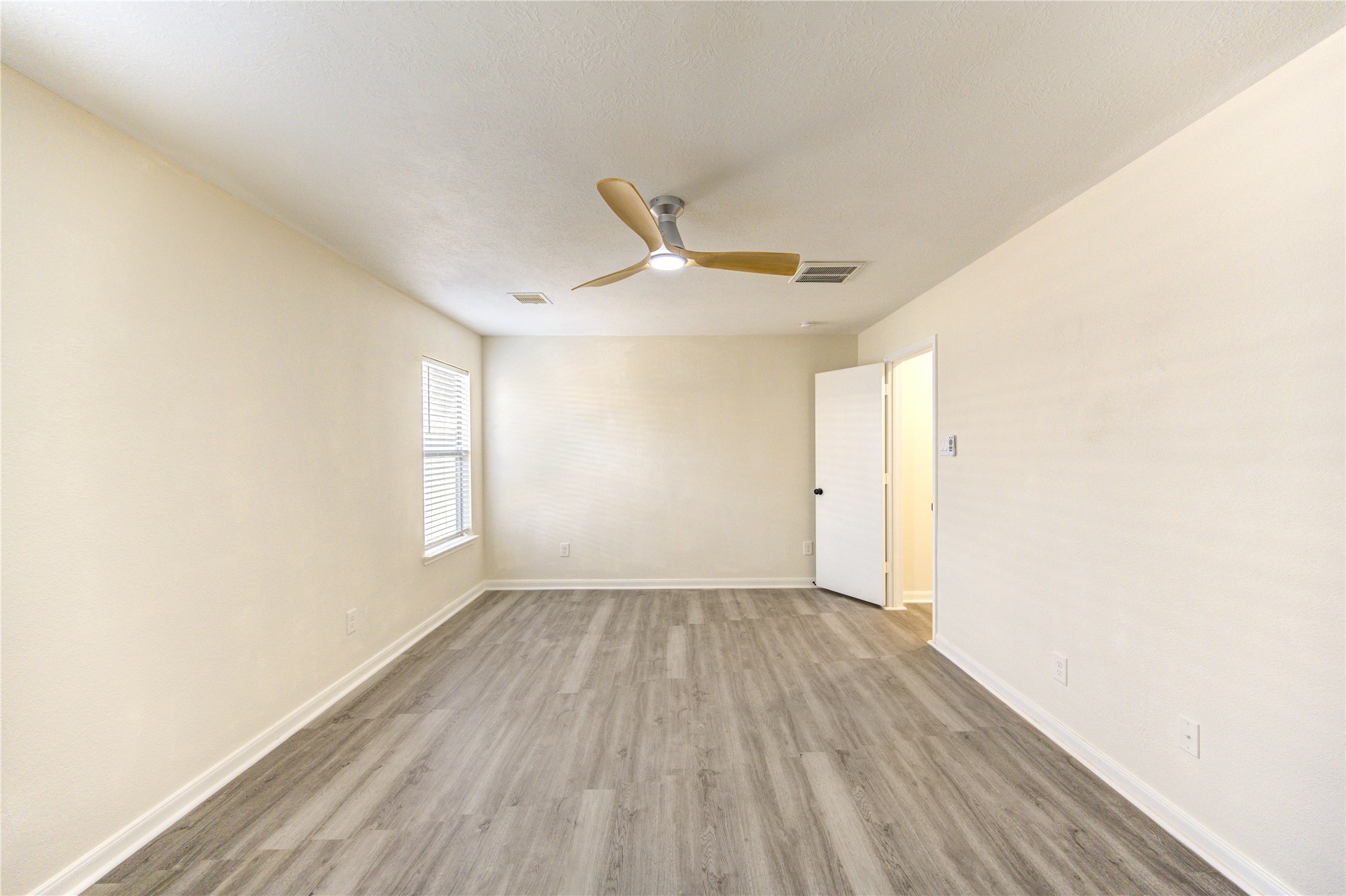 1010 Hummingbird Point Lane Houston, TX 77090 - Photo 34 of 50 a view of a room with wooden floor and a ceiling fan