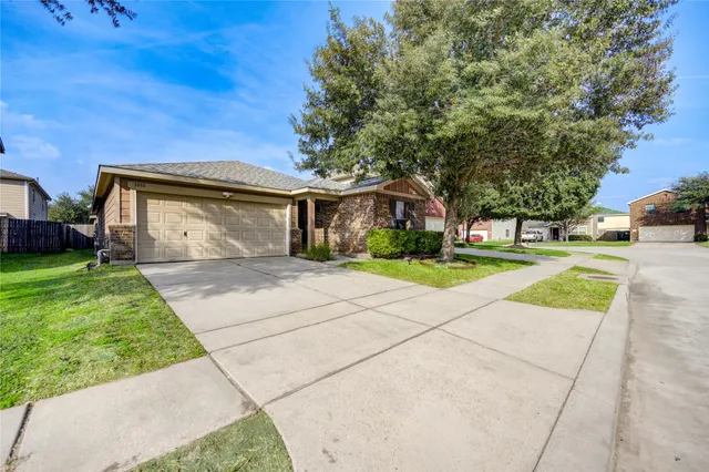a front view of a house with a yard and trees