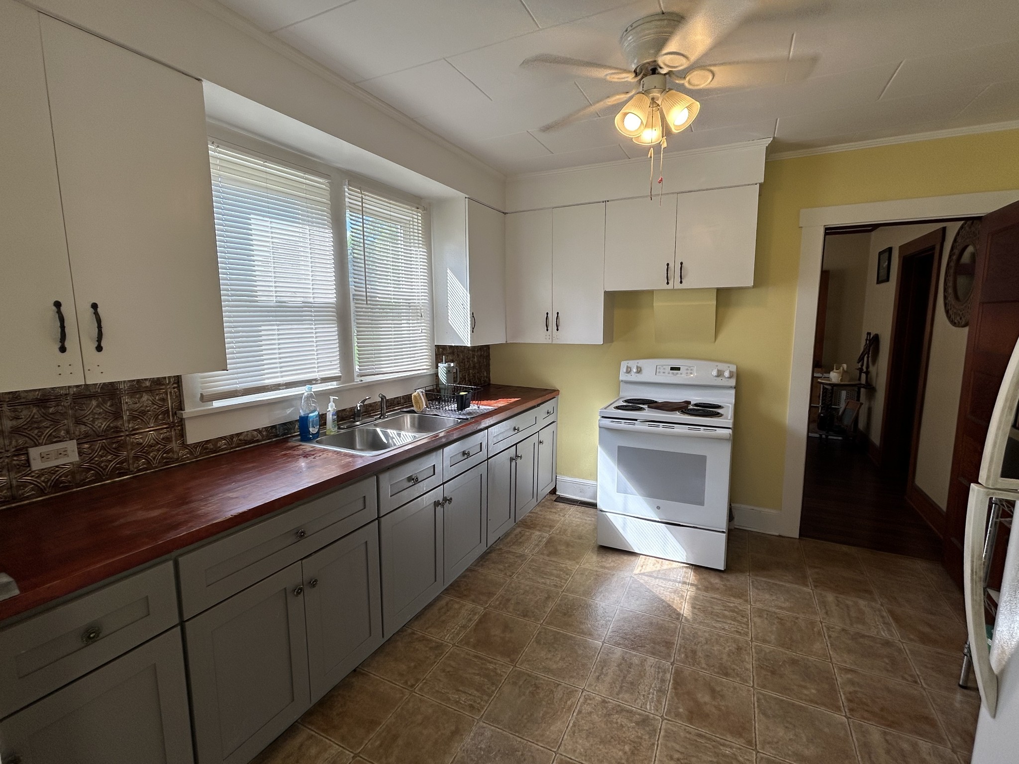 110 East Main Street Loretto, TN 38469 - Photo 5 of 10 a kitchen with a sink cabinets and stainless steel appliances