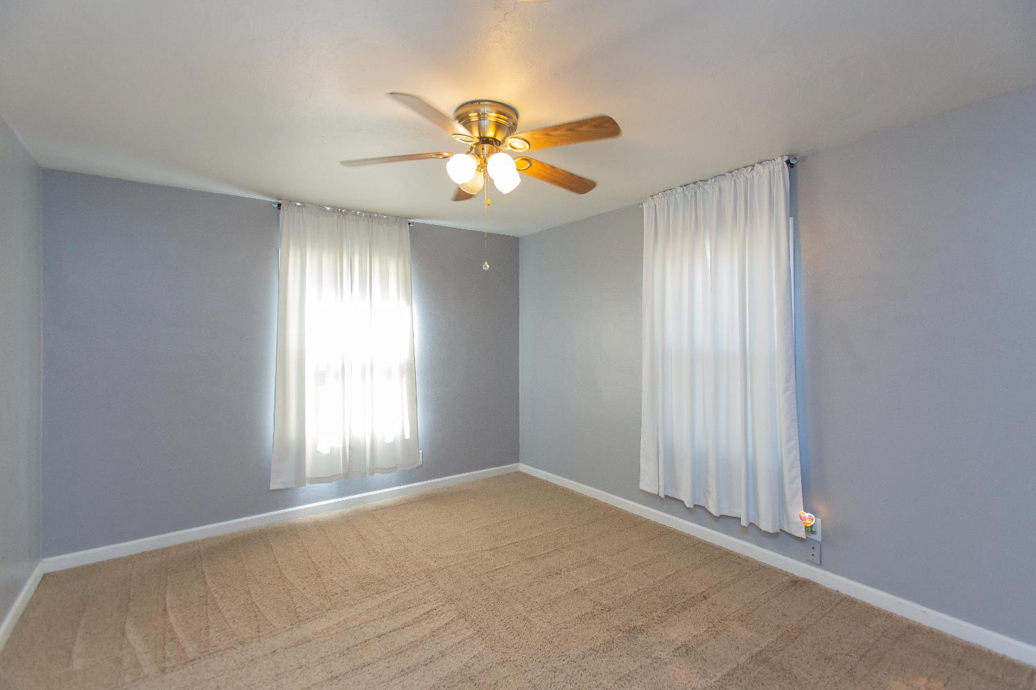 401 Fortuna Avenue Modesto, CA 95354 - Photo 18 of 43 a view of an empty room with window and chandelier fan