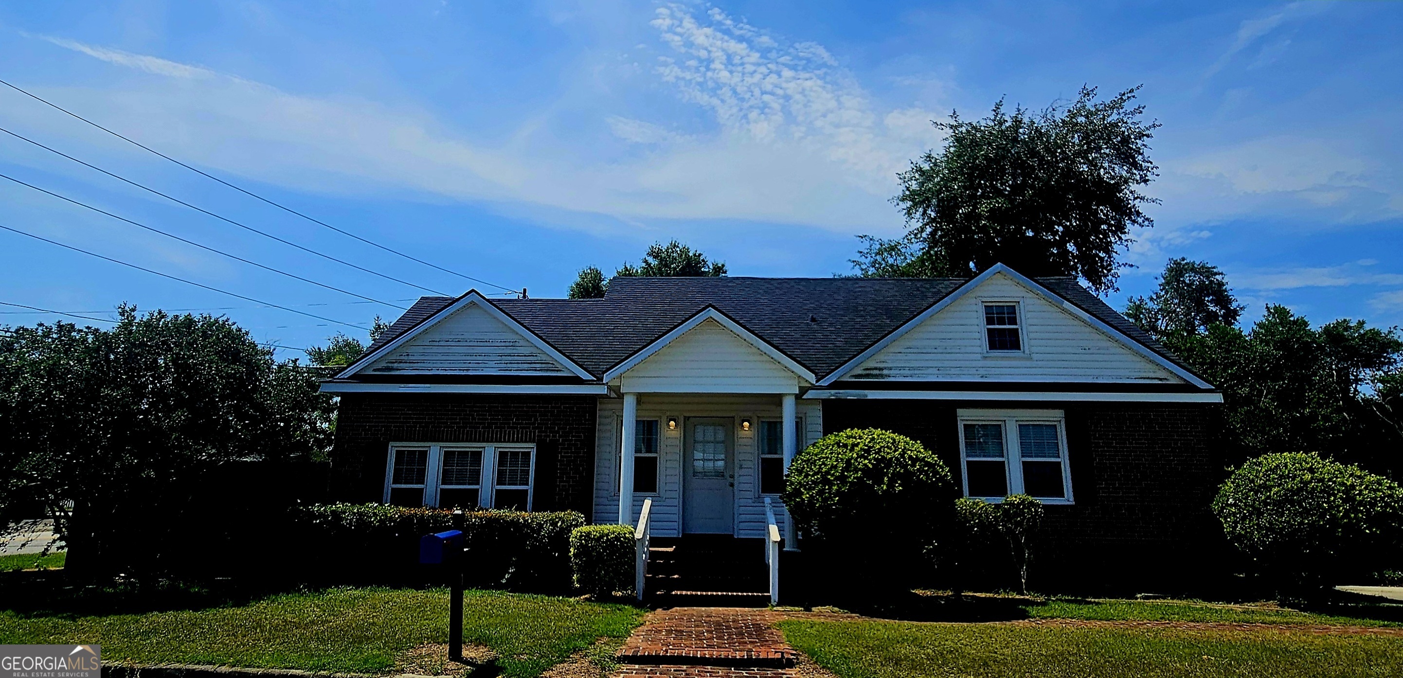a front view of a house with garden