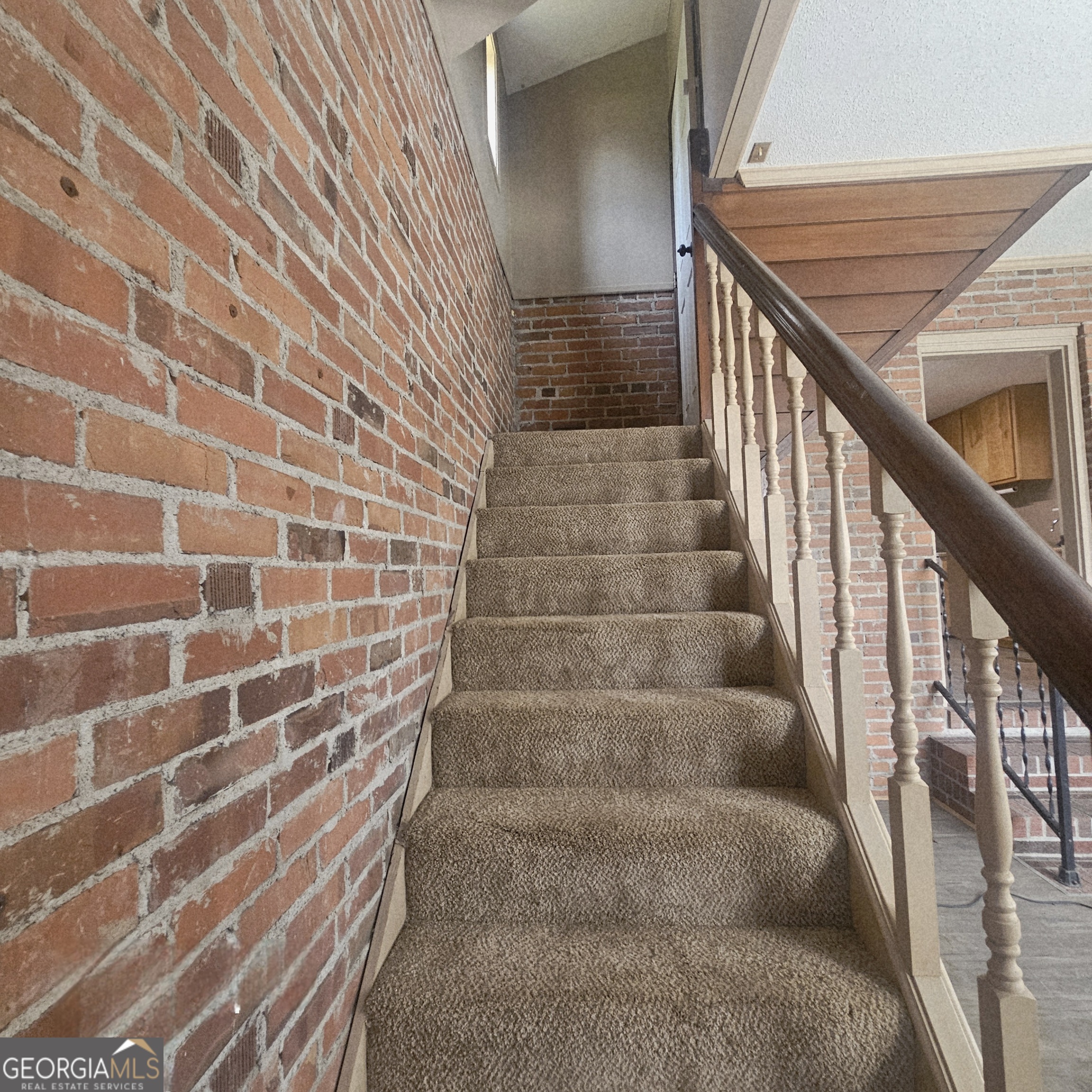 107 East Liberty Street Claxton, GA 30417 - Photo 16 of 29 a view of wooden staircase with a white door