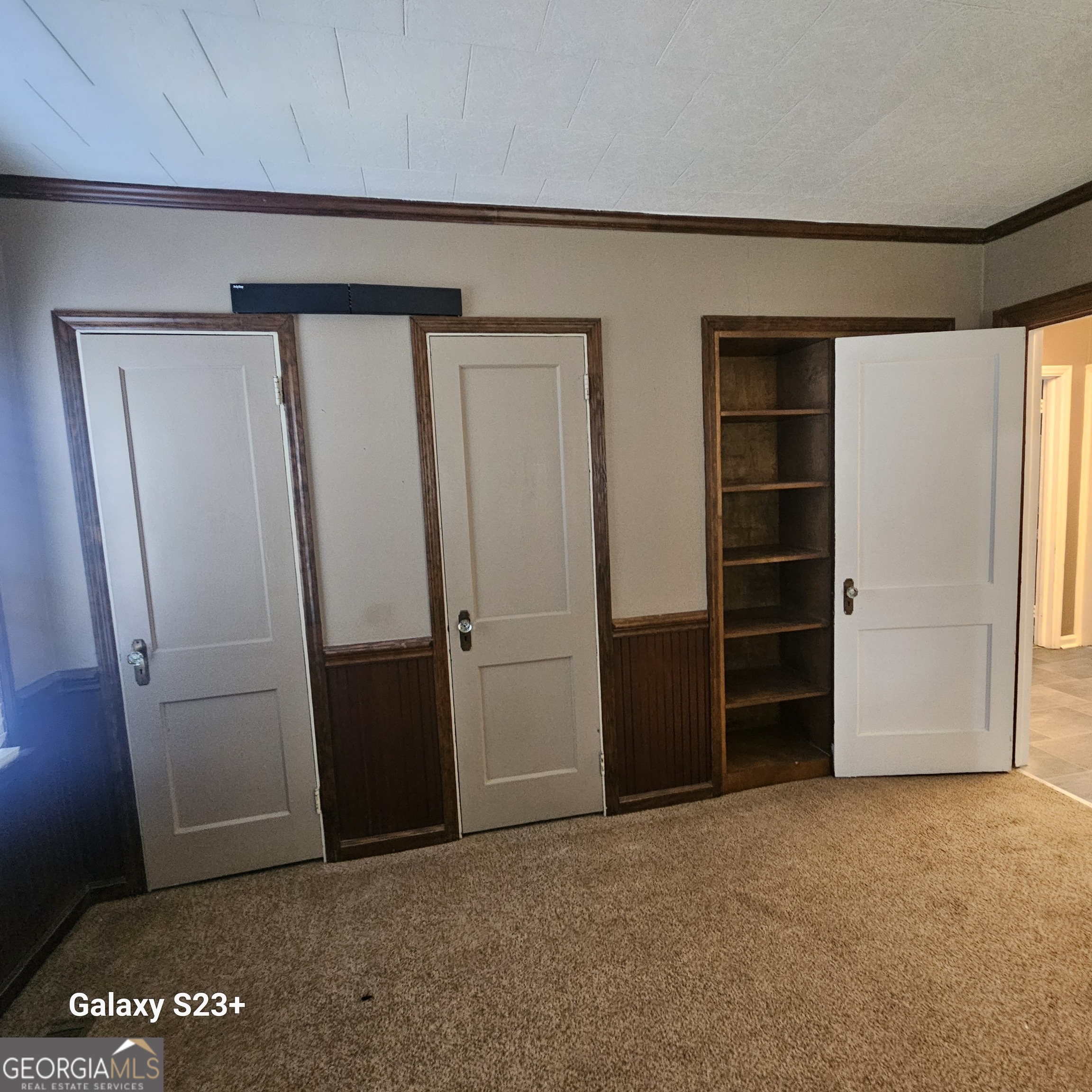 107 East Liberty Street Claxton, GA 30417 - Photo 17 of 29 an empty room with closet and wooden floor
