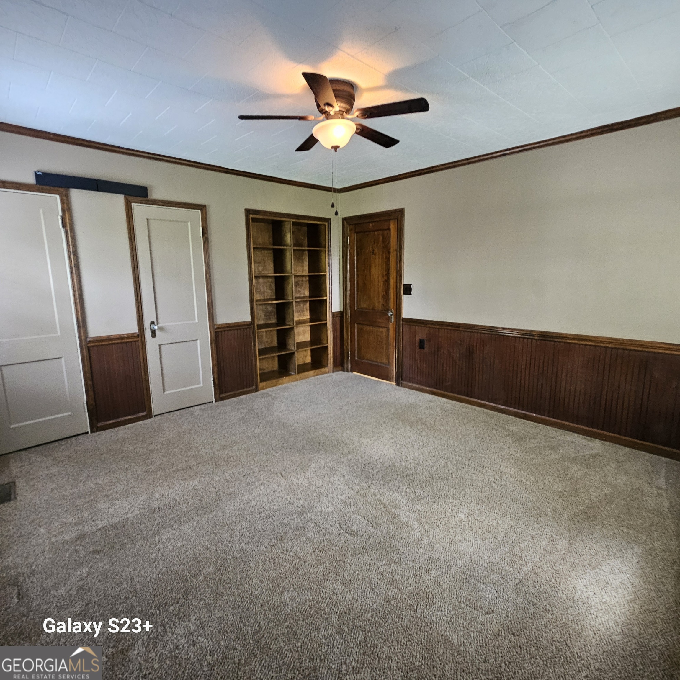 107 East Liberty Street Claxton, GA 30417 - Photo 19 of 29 a view of an empty room with a ceiling fan
