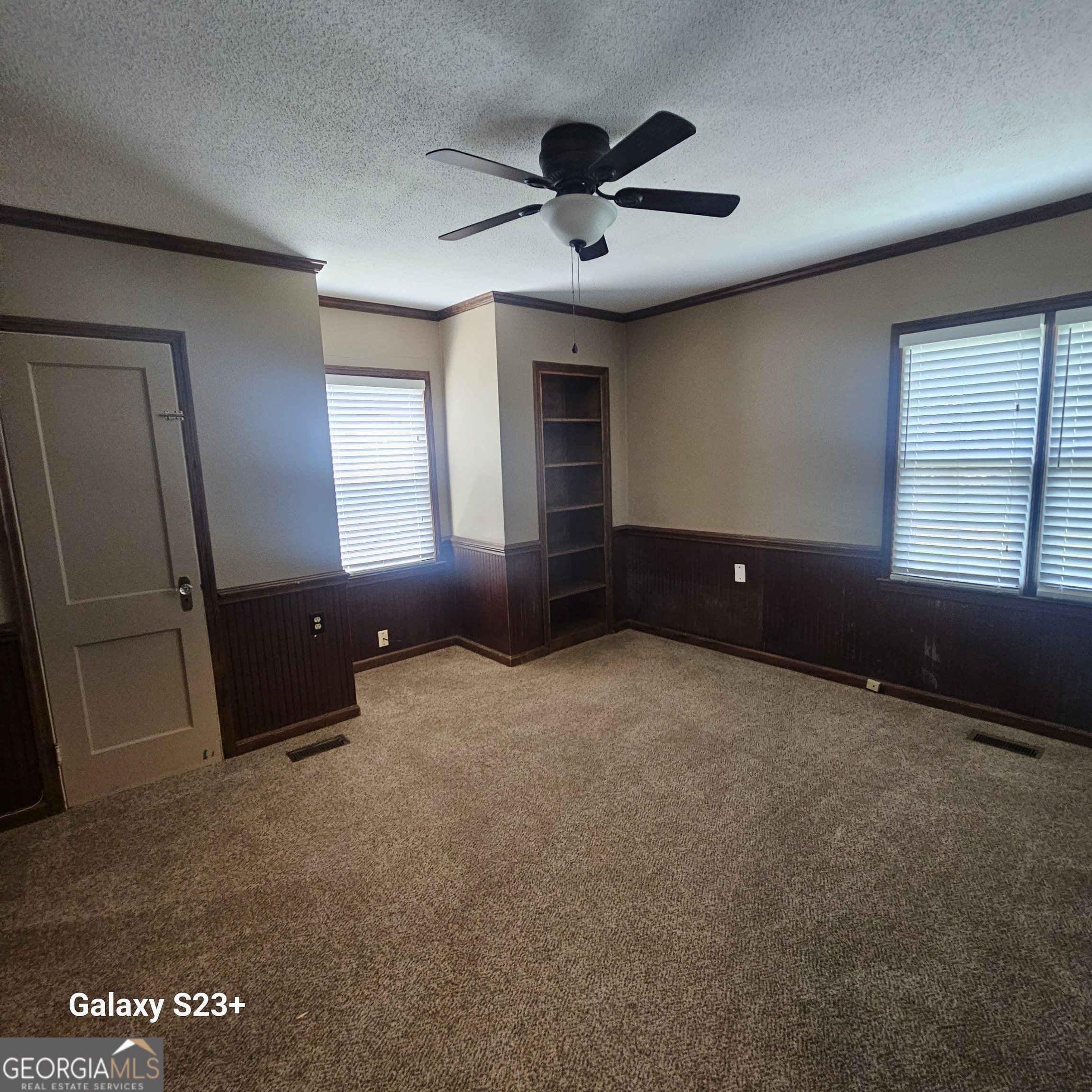 107 East Liberty Street Claxton, GA 30417 - Photo 20 of 29 a view of wooden floor and windows in a room