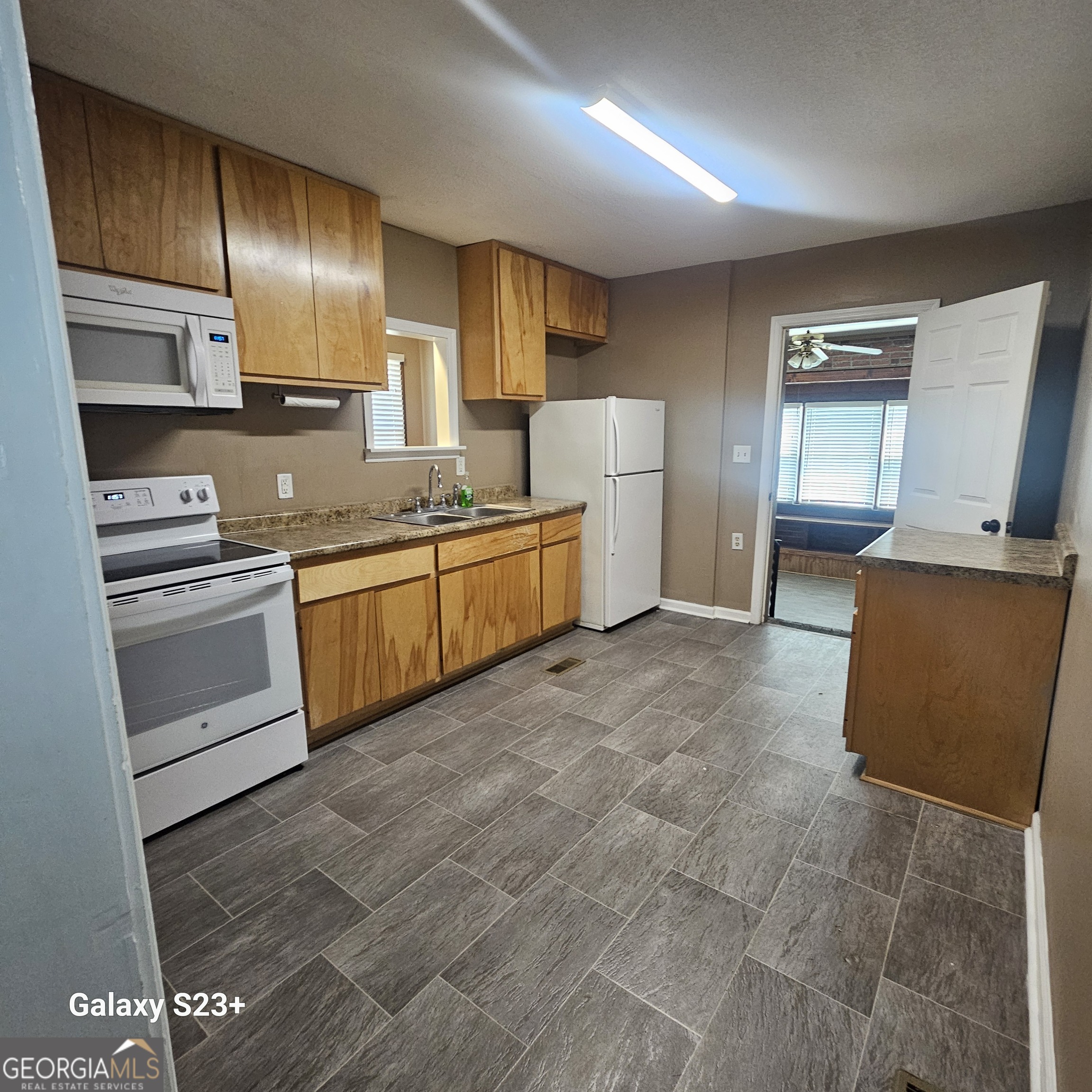107 East Liberty Street Claxton, GA 30417 - Photo 4 of 29 a large kitchen with cabinets and stainless steel appliances