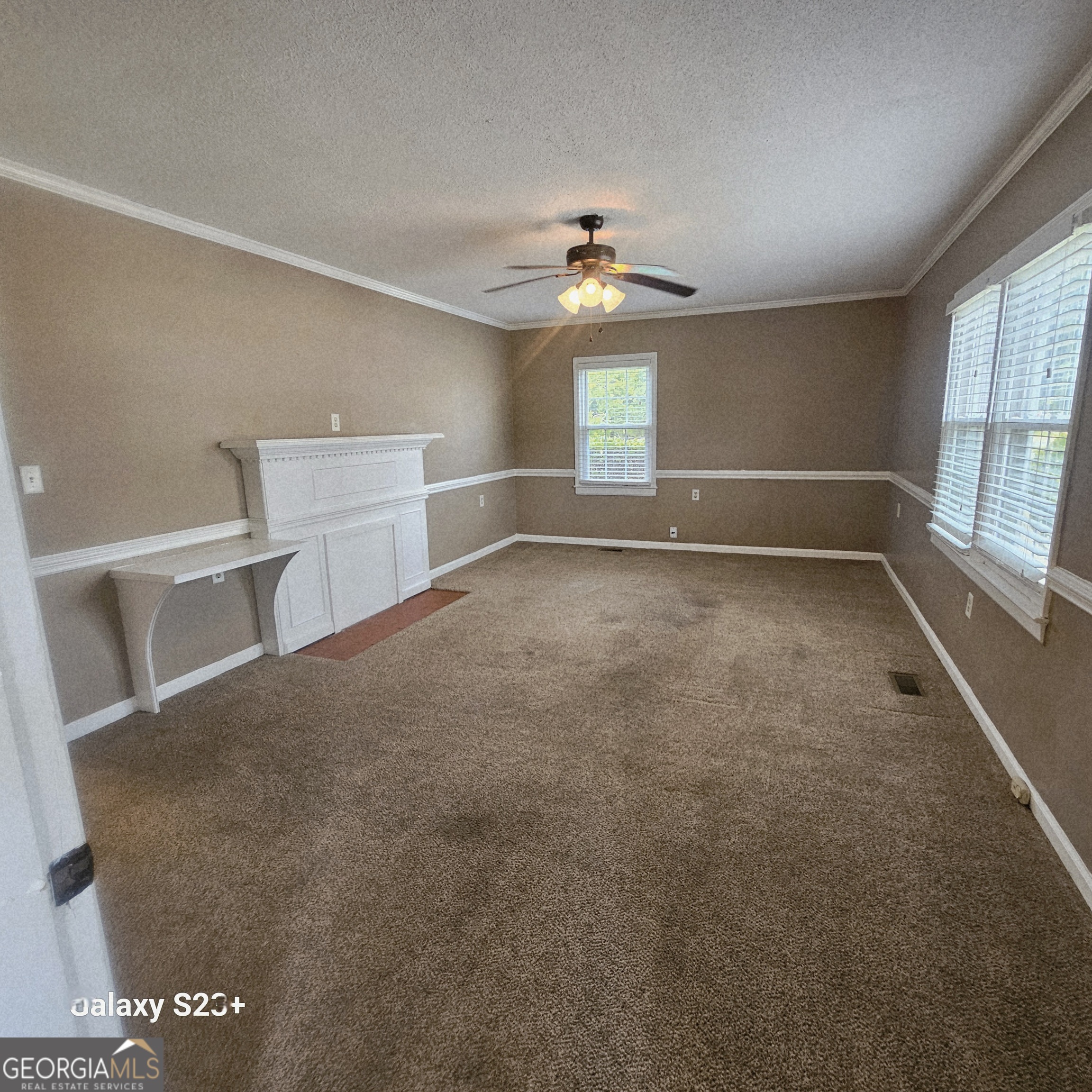 107 East Liberty Street Claxton, GA 30417 - Photo 5 of 29 a view of an empty room with a window