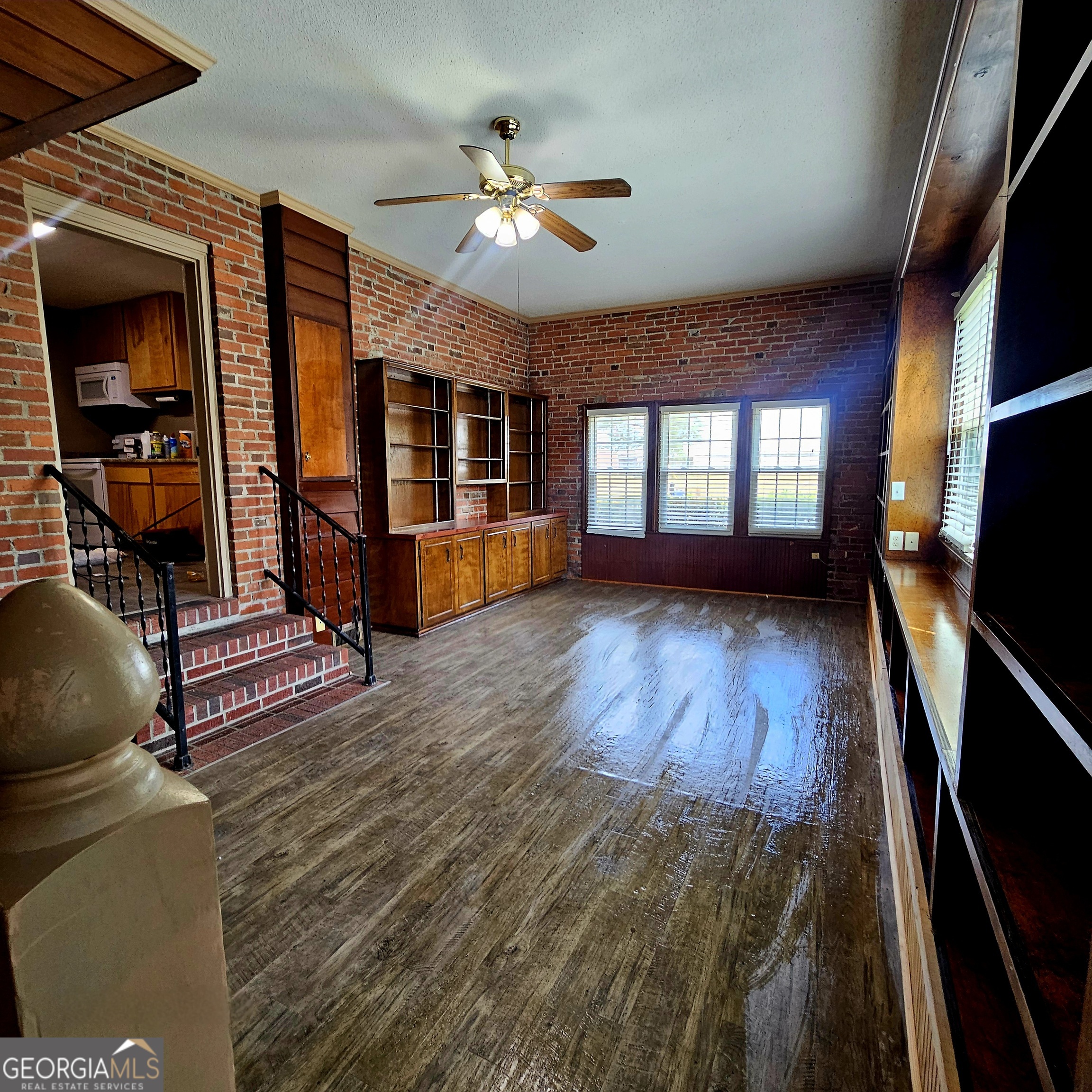 107 East Liberty Street Claxton, GA 30417 - Photo 8 of 29 a living room with couches bookshelf and a stove