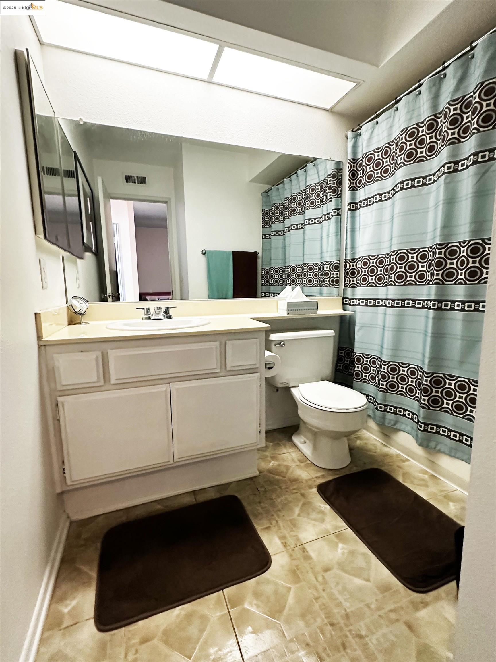 13305 Meyer Road, Unit B Whittier, CA 90605 - Photo 2 of 17 a bathroom with a sink a toilet and mirror