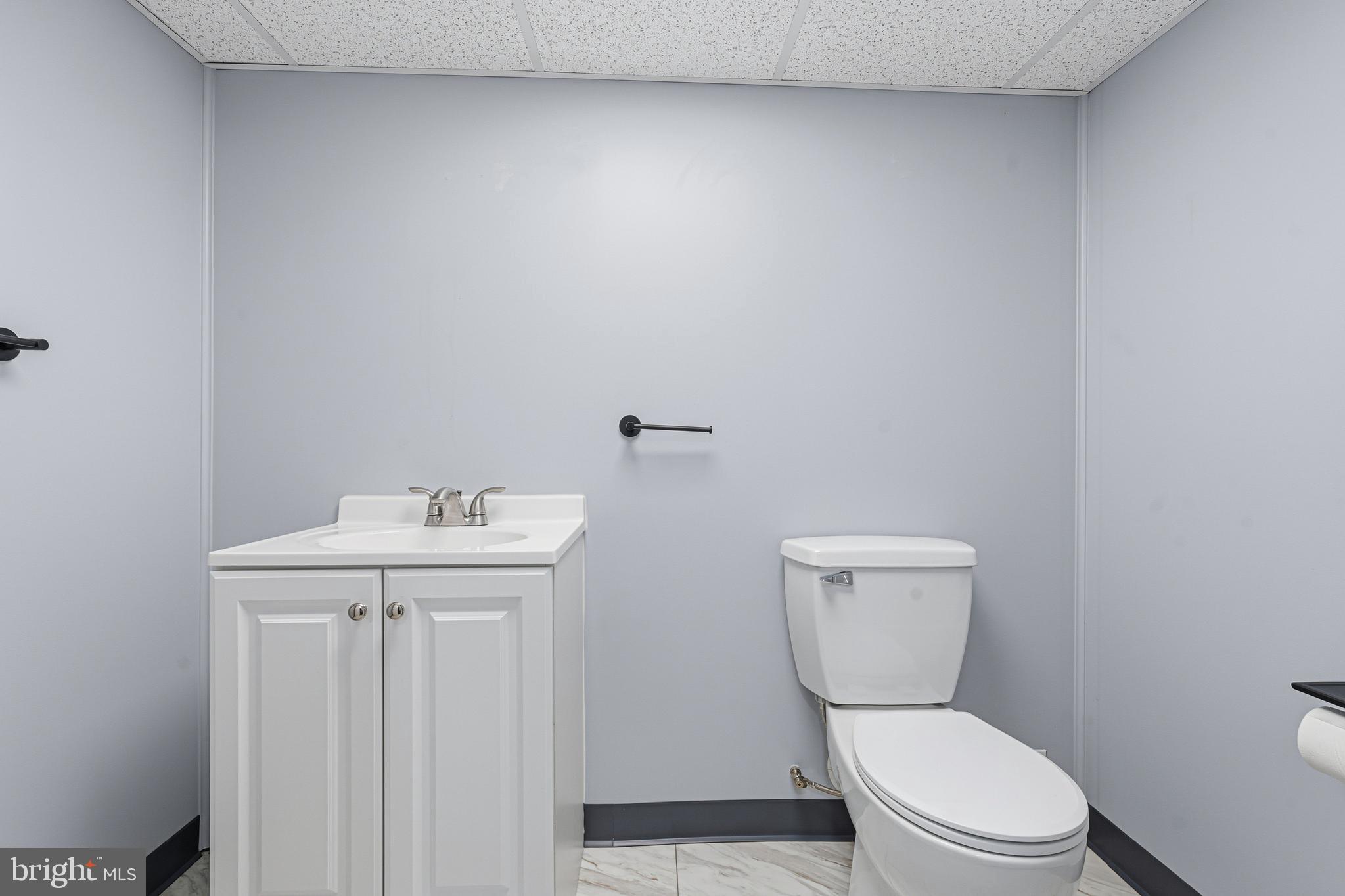 5127 Terrace Drive Nottingham, MD 21236 - Photo 22 of 33 a white toilet sitting next to a bathroom sink