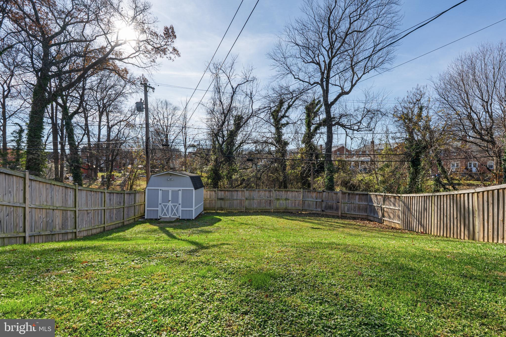 5127 Terrace Drive Nottingham, MD 21236 - Photo 28 of 33 a view of a backyard with large trees and wooden fence