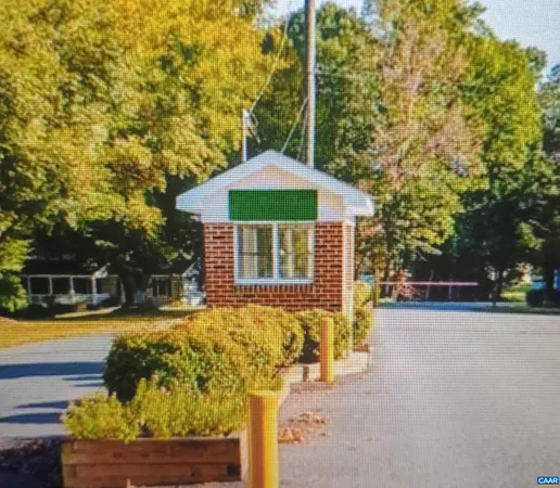 a front view of a house with swimming pool and sitting area