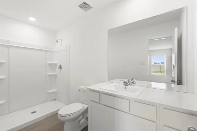 a bathroom with a sink toilet and shower