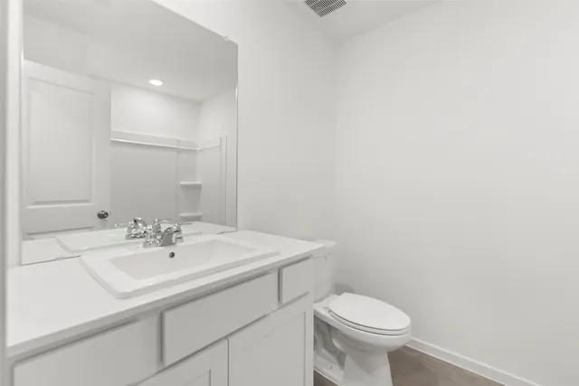 a bathroom with a sink a toilet and mirror