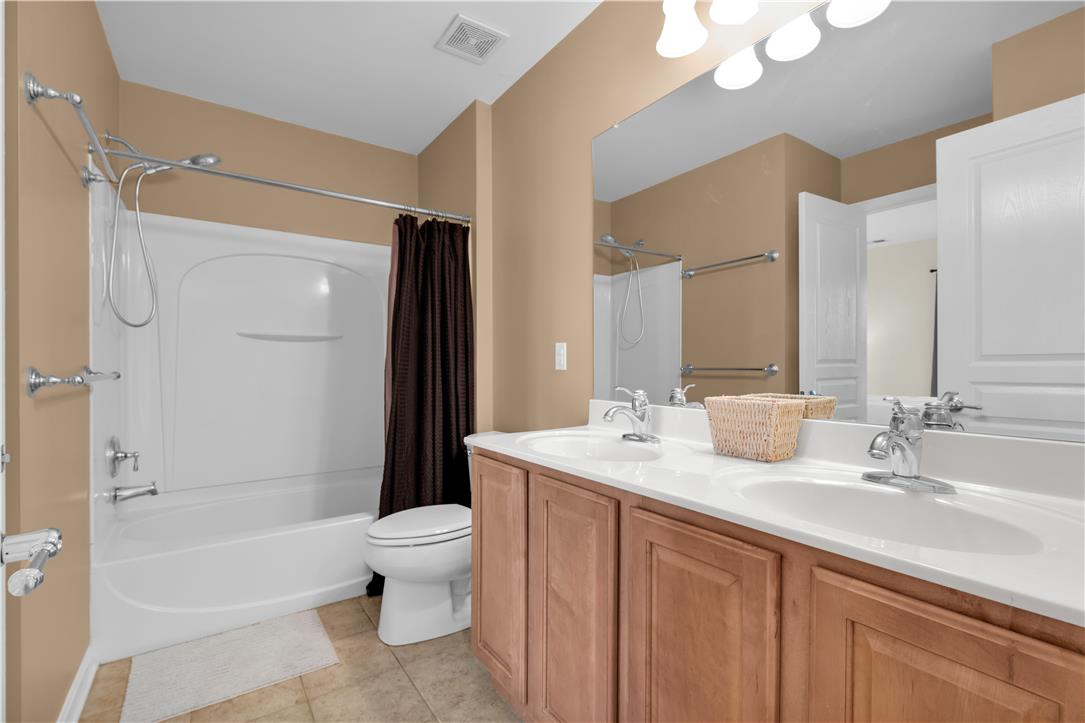 1709 Travers Road Breinigsville, PA 18031 - Photo 38 of 55 Dual vanity sinks and a shower-tub combo create a functional and well-appointed bathroom space.