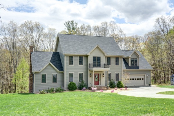 45 Putnam Hill Road Sutton, MA 01590 - Photo 1 of 30 a front view of a house with a yard and trees