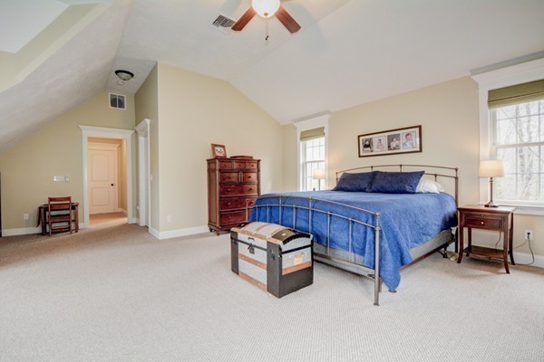 45 Putnam Hill Road Sutton, MA 01590 - Photo 14 of 30 a bedroom with a bed and a chandelier