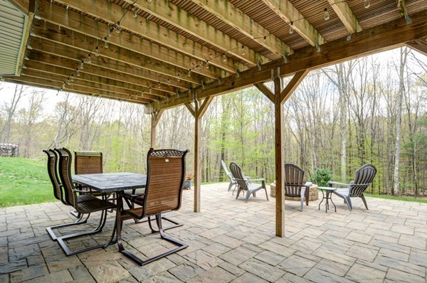 45 Putnam Hill Road Sutton, MA 01590 - Photo 28 of 30 a patio with glass top table and chairs