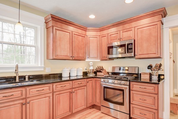45 Putnam Hill Road Sutton, MA 01590 - Photo 7 of 30 a kitchen with stainless steel appliances granite countertop white cabinets sink and window