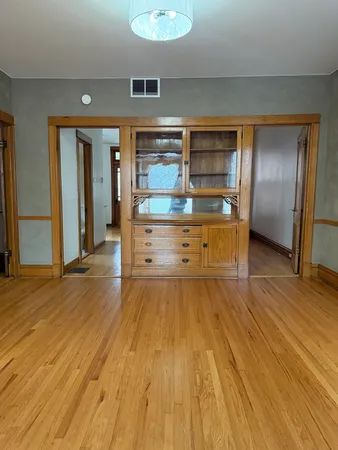 a room with wooden floor and cabinets