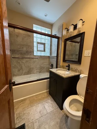 a bathroom with a sink vanity mirror and toilet