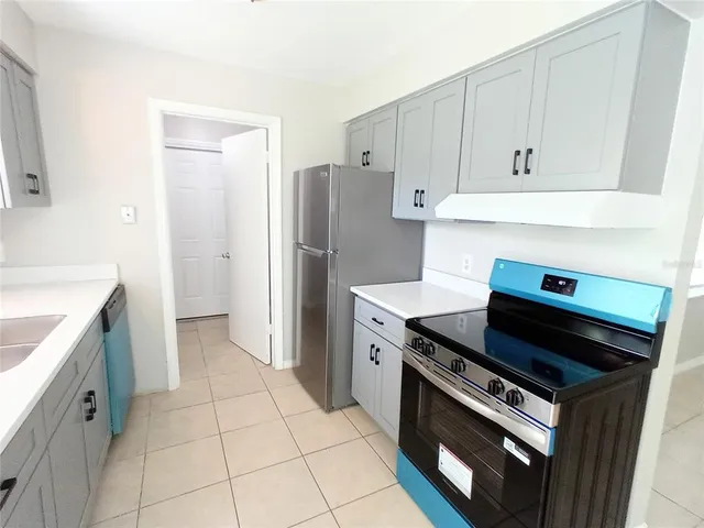 a kitchen with a stove and a refrigerator