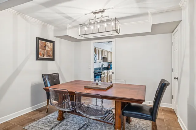 a view of a dining room with furniture a chandelier and wooden floor