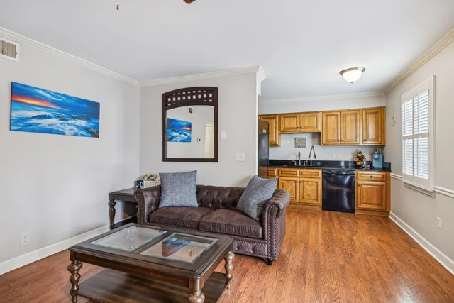 a living room with furniture and wooden floor
