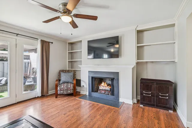a living room with furniture a flat screen tv and a fireplace