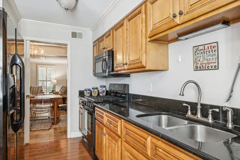 a kitchen with stainless steel appliances granite countertop a sink and cabinets