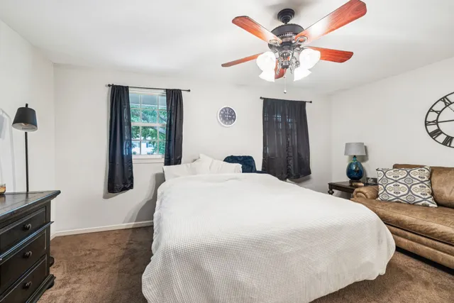 a bedroom with a large bed and a chandelier