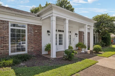 a front view of a house with garden