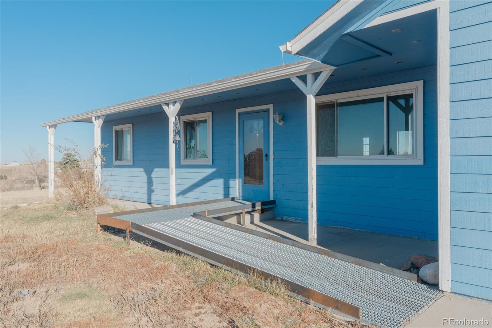 45922 Summit Road Parker, CO 80138 - Photo 5 of 35 front view of a house with a yard