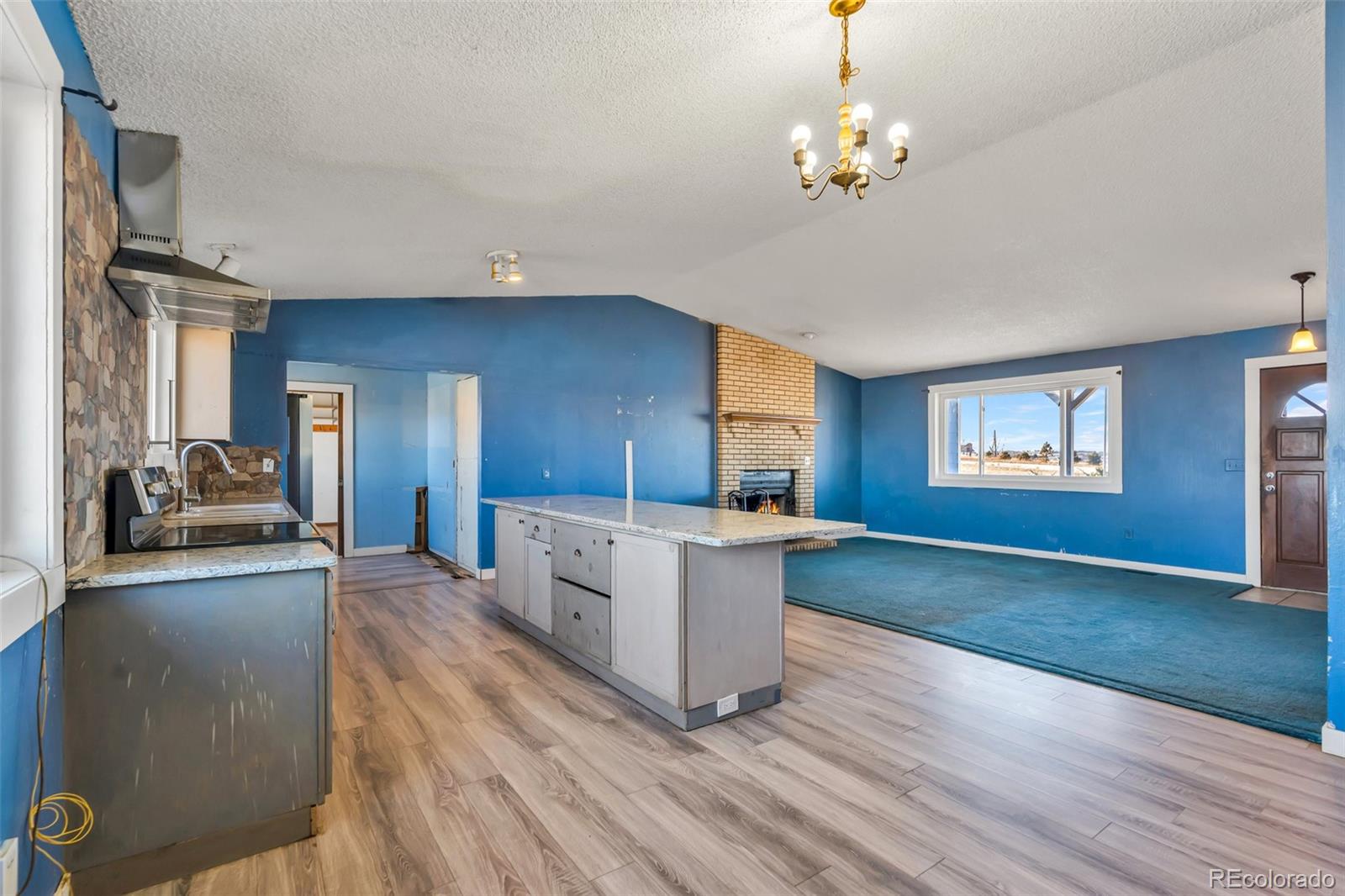 45922 Summit Road Parker, CO 80138 - Photo 9 of 35 a living room with kitchen island granite countertop furniture and a wooden floor