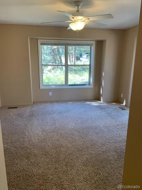 201 Bluebird Drive Bailey, CO 80421 - Photo 22 of 45 an empty room with windows and mountain view