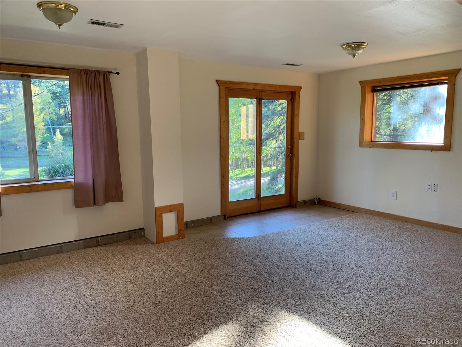 201 Bluebird Drive Bailey, CO 80421 - Photo 30 of 45 an empty room with windows