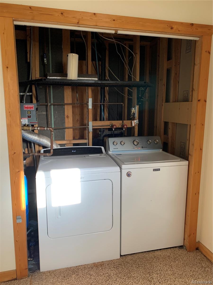 201 Bluebird Drive Bailey, CO 80421 - Photo 31 of 45 a utility room with dryer and washer