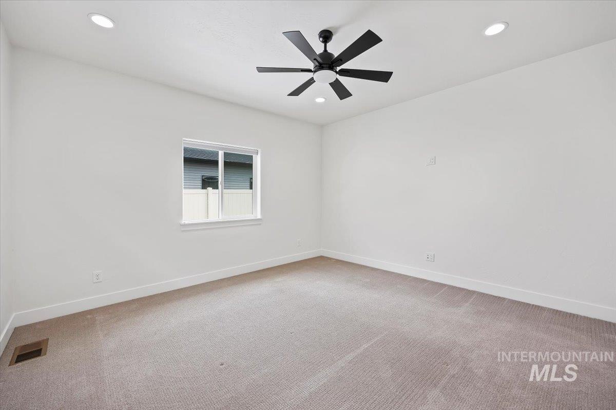 924 Trapper Peak Road Kimberly, ID 83341 - Photo 20 of 40 Empty room featuring light colored carpet, recessed lighting, and a ceiling fan